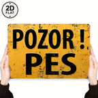 Vintage yellow metal tin sign with large black text 'Pozor! Pes', held in two hands