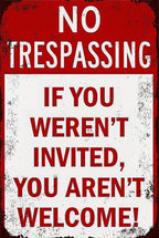 Vintage metal no trespassing sign with distressed edges and bold warning message.