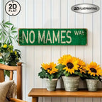 Vintage green tin sign with 'NO MAMES WAY' on a white wall, sunflowers in pots below