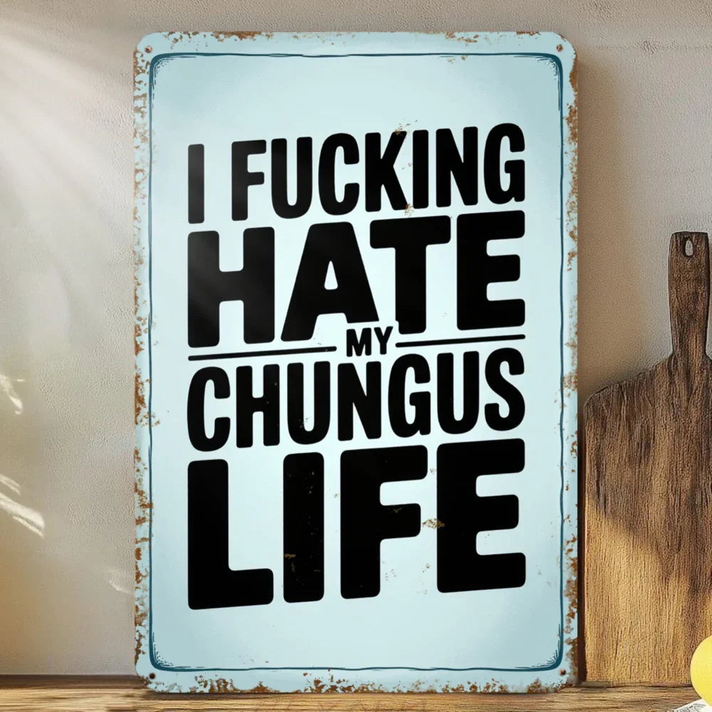 Funny vintage tin sign with bold black text and distressed edges on a kitchen wall