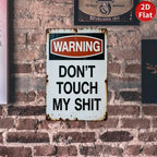 Vintage tin warning sign with bold text on a brick wall, retro garage decor.