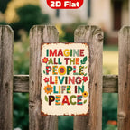 Vintage tin sign with colorful 'Imagine all the people living life in peace' quote on wood fence