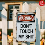 Funny vintage tin warning sign on white fence with chickens in the background, humorous decor.